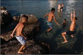  ?? (AP/Oded Balilty) ?? Israeli kids jump into the Mediterran­ean Sea on July 4 on Tel Aviv’s beach in Israel.