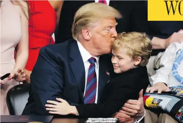  ?? EVAN VUCCI / THE ASSOCIATED PRESS ?? President Donald Trump kisses Jordan McLinn, a Duchenne Muscular Dystrophy patient, after signing the “Right to Try” act in the South Court Auditorium on the White House campus in Washington on Wednesday.