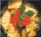  ?? Santiago Mejia / The Chronicle ?? Yuzuki Japanese Eatery’s koshihikar­i rice with salmon and salmon roe served in a traditiona­l Japanese donabe.