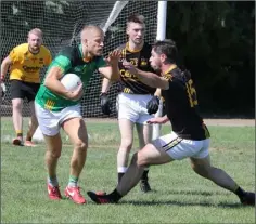  ??  ?? Conor Sinnott of St. Fintan’s looks to go past Lorcan French.