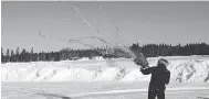  ??  ?? Biologist Serge Couturier fires a net gun at the airport in Wawa, Ont., earlier this month in preparatio­n for the relocation of Michipicot­en Island caribou.