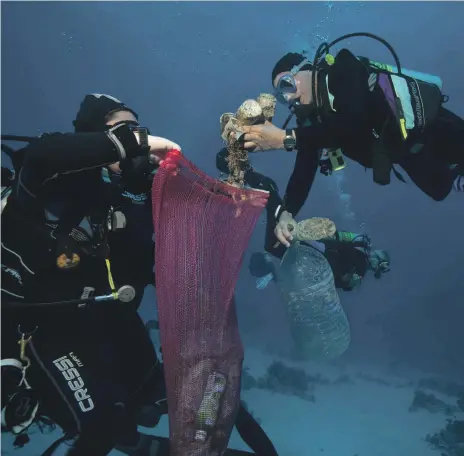  ?? AP ?? Divers collect plastic debris during a clean-up by Camel Dive Club, at a site off Sharm El Sheikh