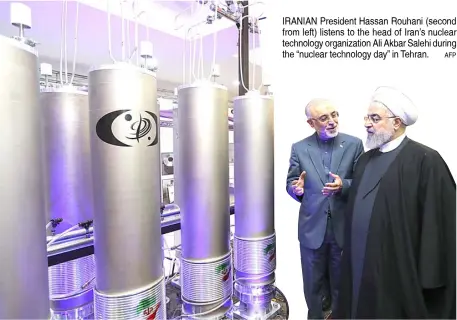  ??  ?? IRANIAN President Hassan Rouhani (second from left) listens to the head of Iran’s nuclear technology organizati­on Ali Akbar Salehi during the “nuclear technology day” in Tehran.