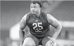 ?? MICHAEL CONROY/AP ?? USC offensive lineman Austin Jackson runs a drill at the NFL scouting combine.