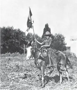  ??  ?? Early Ranch School student George May (1919-23) with a Boy Scouts flag.