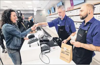  ?? CP PHOTO ?? Alicia Wright makes a purchase at the Nova Scotia Liquor Corporatio­n cannabis store in Halifax on Wednesday. Residents can now make their purchases at 12 liquor stores across the province and online.