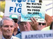  ?? AP PHOTO BY RICH PEDRONCELL­I ?? California farmers rally at the Capitol to protest a proposal by state water officials to increase water flows for the lower San Joaquin River to protect fish, at the Capitol, Monday, Aug. 20.