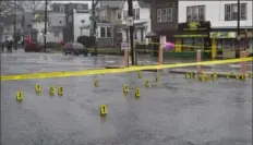  ?? Joe Lambert/Associated Press ?? Evidence markers are seen following a shooting in northeast Philadelph­ia on Wednesday. Four shootings over four days in Philadelph­ia left three dead and 12 injured, many of them children — violence that put renewed focus on safety within the sprawling mass transit system and gave ammunition to critics of the city’s progressiv­e chief prosecutor.