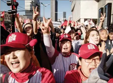  ?? ED JONES/AFP ?? A group of women cheer as they attend a rally for South Korean presidenti­al candidate Hong Jun-pyo in Seoul on May 5.