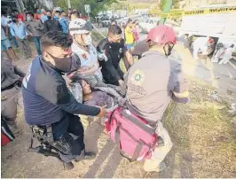  ?? AP ?? An injured migrant woman is moved by rescue personnel Thursday from the site of an accident near Tuxtla Gutierrez, Chiapas state, Mexico. Mexican authoritie­s say at least 55 were killed.