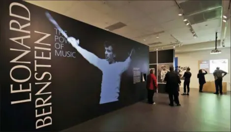  ?? MATT SLOCUM — THE ASSOCIATED PRESS ?? Journalist­s walk through the Leonard Bernstein exhibit during a press preview at the National Museum of American Jewish History in Philadelph­ia.