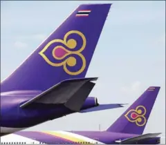  ?? CHRISTOPHE ARCHAMBAUL­T/AFP ?? Thai Airways planes sit on the tarmac in 2014 at Bangkok’s Suvarnabhu­mi internatio­nal aiport.