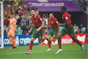  ?? Ram Chand ?? Portugal’s midfielder Bruno Fernandes (right) celebrates after scoring against Uruguay during the Qatar 2022 Group H at the Lusail Stadium. PICTURE: