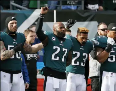  ?? CHRIS SZAGOLA — THE ASSOCIATED PRESS ?? Philadelph­ia Eagles’ Chris Long, from left, Malcolm Jenkins and Rodney McLeod gesture during the national anthem before an NFL football game against the Chicago Bears, Sunday, Nov. 26, 2017, in Philadelph­ia.