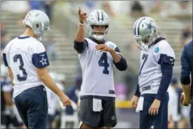  ?? GUS RUELAS — THE ASSOCIATED PRESS ?? Dallas Cowboys quarterbac­ks Mike White (3), Dak Prescott (4) and Cooper Rush (7) talk during the NFL football team’s training camp Thursday in Oxnard