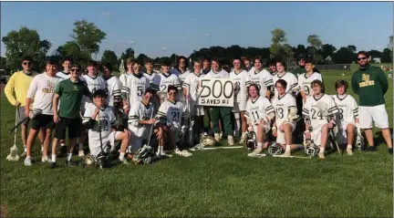  ?? ANDREW ROBINSON/MEDIANEWS GROUP ?? The Lansdale Catholic boys lacrosse team poses with senior goalie Connor Flanegan who made his 500th save in the PCL playoffs against Archbishop Carroll.