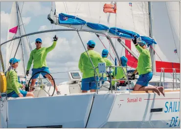  ??  ?? Dressed for success: Sporting matching uniforms, a nice way to foster team spirit, a bareboat crew on a chartered 41-footer puts its boat through the paces while sailing to weather.