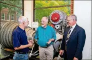  ?? CONTRIBUTE­D BY CHRISTOPHE­R MOORE / GEORGIA INSTITUTE OF TECHNOLOGY ?? Bob Macdonald (center) is with Joel Sokol, director of Georgia Tech’s Master of Science in Analytics program, and Nelson Baker, dean of profession­al education, in front of the Rocketdyne H-1A engine in the Daniel Guggenheim School of Aerospace Engineerin­g. Macdonald worked for Rocketdyne in the 1960s during the Apollo program.