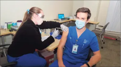  ?? Bridgeort Hospital / Contribute­d photo ?? Marc Shackett, a nurse in the Bridgeport Hospital Critical Care Resource Support Unit, receives his COVID-19 vaccine at Bridgeport Hospital on Wednesday.