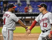  ?? ERIC ESPADA /GETTY IMAGES ?? Manager Dave Martinez (with Asdrubal Cabrera) gets strong backing from his players. He was a journeyman player for 16 years, so he strongly identifies with them.