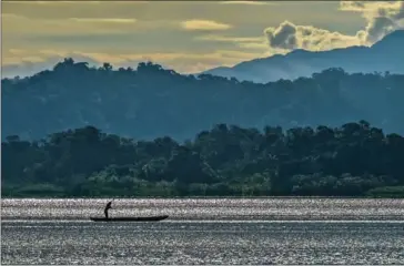  ?? AFP ?? A fisherman sailing on the Pacific Ocean at sunrise in the Uramba Bahia Malaga national natural park in Colombia. Uramba Bahia Malaga is part of the ‘Hot Spots’ of conservati­on of the planet. It has a great marine and continenta­l biodiversi­ty and is one of the favorite places for humpback whales to breed and breed their whales.