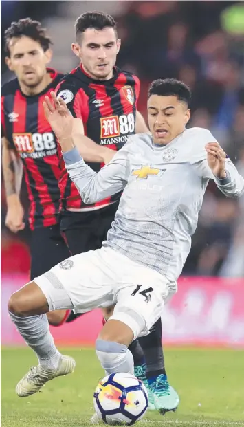  ?? Picture: AP ?? DEVILS IN WHITE: Manchester United star Jesse Lingard battles with Bournemout­h's Lewis Cook for the ball. Goal scorer Romelu Lukaku and Paul Pogba (left) celebrate.