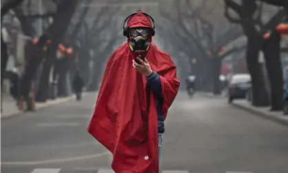  ??  ?? A Chinese man wears a protective mask, goggles and coat during the lunar new year holiday in Beijing. Health authoritie­s are urging people to take precaution­s against the spread of the coronaviru­s. Photograph: Kevin Frayer/Getty Images