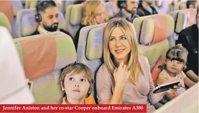  ??  ?? Jennifer Aniston and her co-star Cooper onboard Emirates A380