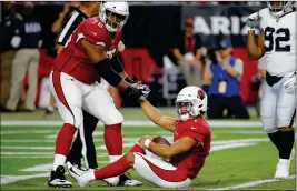  ?? ASSOCIATED PRESS ?? ARIZONA CARDINALS quarterbac­k Kyler Murray (1) is helped up by offensive tackle Marcus Gilbert (76) after being sacked for a safety against the Oakland Raiders during a game, Thursday in Glendale.