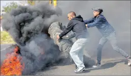  ??  ?? Residents protesting over a lack of services in Ennerdale, in Joburg’s south, blockaded roads with rocks and burning tyres.