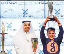  ?? Ahmed Ramzan/Gulf News ?? Abdul Hamid Ahmad, Executive Director, Publishing and Editor-in-Chief, Gulf News, handing over the owner’s trophy to Jorger Wagner, Anna Wagner, Dan Summers and M. Scott Summers after Mind Your Biscuits won the Dubai Golden Shaheen race, sponsored by...