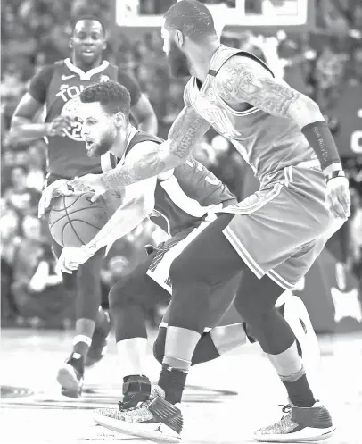  ?? ASSOCIATED PRESS ?? Golden State Warriors' Stephen Curry, left, drives the ball against Boston Celtics' Marcus Morris during the first half of an NBA basketball game in Oakland, Calif.