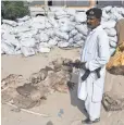  ?? ASIF HASSAN, AFP/ GETTY IMAGES ?? A Pakistani customs official guards confiscate­d donkey hides in Karachi that were set to be illegally exported to China on April 27.