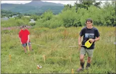  ??  ?? Fraser and Scott measuring out plots of Arran for sale.