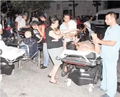  ?? — AFP photo ?? People receive medical treatment in the garden of the Bodrum State Hospital following an earthquake in Bodrum, southweste­rn Turkey.