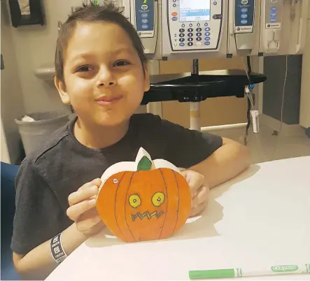  ??  ?? Eight-year-old Ryken Covino of Edmonton is taking part in a revolution­ary clinical trial where he received CD19 CAR-T cell therapy at Toronto’s Hospital for Sick Children. He’s concerned that he’ll have to miss Halloween, but this treat is so much more important.