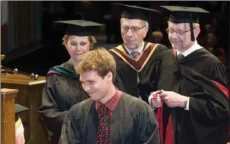  ?? HAMILTON SPECTATOR FILE PHOTO ?? Bill Walsh, back row centre, helped establish McMaster’s medical school. He is pictured with his grandson Simon Oczkowski, foreground, at his graduation from medical school in 2009 where he became the third-generation doctor in his family.