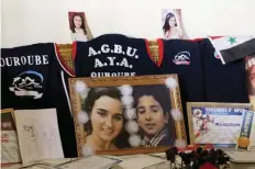  ??  ?? ALEPPO: A picture taken on Tuesday shows portraits of Syrian athlete Mireille Hindoyan, 20, (L) and her 12-year-old brother Arman, who were killed during shelling on the government controlled area of Aleppo on September 30, 2016. On the day she was...