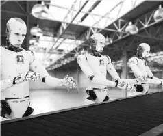  ??  ?? Robots fit black, soundproof­ing rubber tubes to the inner rim of car doors, a task once done entirely by hand, on the more than 5,000 or so car doors that pass through the production line each day. Human workers do final checks on the tube's placement