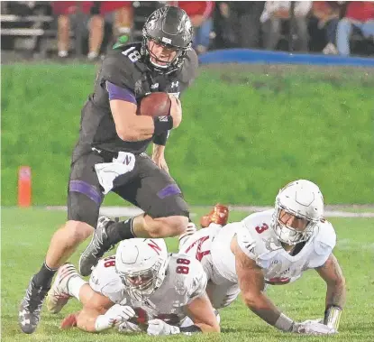  ??  ?? NU quarterbac­k Clayton Thorson threw for 249 yards and ran for a 42- yard touchdown against Nebraska. | DAVID BANKS/ GETTY IMAGES