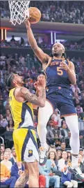  ?? N.Y. Post: Charles Wenzelberg ?? VIEW FROM ABOVE: Precious Achiuwa (5) goes up for a shot over Pacers forward Obi Toppin during the Knicks' 130121 Game 2 win on Wednesday at the Garden. Achiuwa got extra playing time with Mitchell Robinson out.