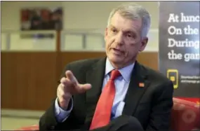  ?? RICHARD DREW — THE ASSOCIATED PRESS ?? Wells Fargo CEO & President Timothy Sloan is interviewe­d in one of his bank’s branches, in New York, Friday. Sloan says that it’s too early to gauge President Donald Trump’s job performanc­e, but says that he will succeed as long as the White House...