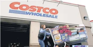  ?? RICK BOWMER, AP ?? Costco, one of America’s largest retailers, stopped doing business with Pacific 9 Transporta­tion, a California trucking company accused of trapping drivers in debt to force them to work overtime.