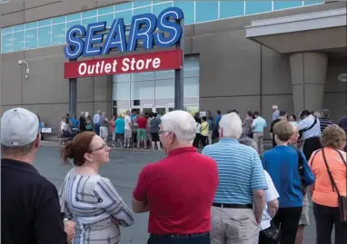  ?? The Canadian Press ?? Shoppers stand in line waiting for a Sears outlet store to open in Halifax on Friday. Dozens of Sears stores destined for closure began liquidatio­n sales Friday, but experts warned bargain hunters to temper their expectatio­ns.