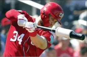  ?? JEFF ROBERSON — THE ASSOCIATED PRESS ?? The Washington Nationals’ Bryce Harper swings in the on-deck circle as he prepares to bat during the fourth inning of an exhibition spring training game against the Houston Astros, Saturday in West Palm Beach, Fla.