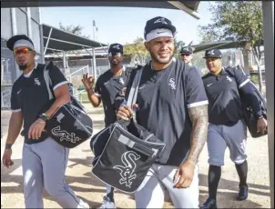  ?? Armando L. Sanchez/Chicago Tribune ?? Jose Abreu, Eloy Jimenez, Yoan Moncada and other White Sox players walk to a practice field during spring training at Camelback Ranch on Feb. 19, 2020.