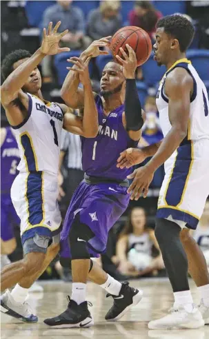  ?? STAFF PHOTO BY ERIN O. SMITH ?? UTC’s Rodney Chatman, left, and Makale Foreman pressure Furman’s John Davis III during Wednesday night’s game at McKenzie Arena. Furman improved to 4-0 in SoCon play with a 73-55 win, but the Mocs took their fifth straight loss and fell 0-4 in the...