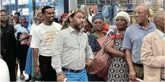  ?? Picture: EUGENE COETZEE ?? IN DEMAND: People queue at Exclusive Books in Walmer where spiritual guide Dr Uzwi-Lezwe Radebe launched his new book at the weekend