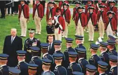  ?? AP ?? President Donald Trump and French President Emmanuel Macron inspect a Guard of Honour in Washington yesterday.