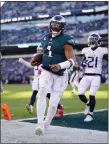  ?? AP PHOTO/ MATT ROURKE, FILE ?? Philadelph­ia Eagles quarterbac­k Jalen Hurts scores a touchdown against the Tennessee Titans during an NFL football game Dec. 4, 2022, in Philadelph­ia.